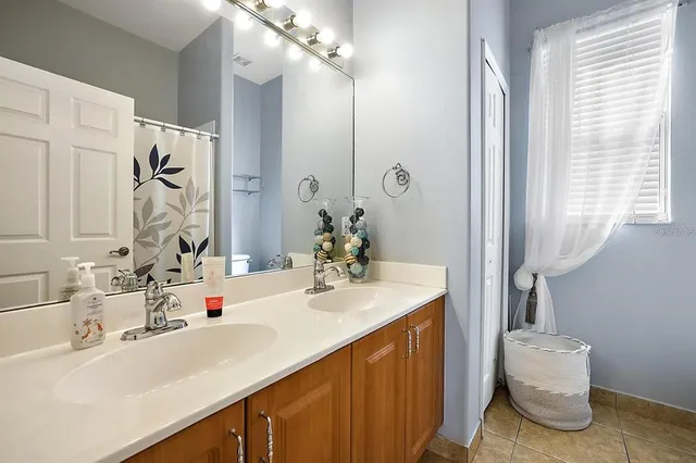 a bathroom with a sink vanity and a mirror
