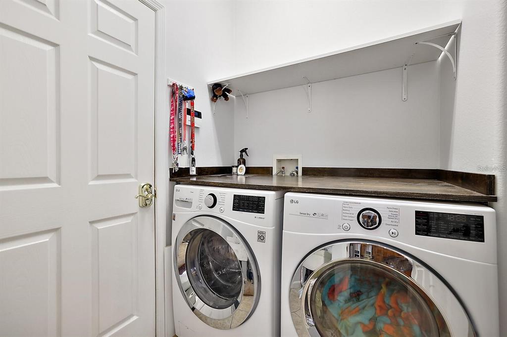 2847 Majestic Isle Drive Clermont, FL 34711 - Photo 21 of 25 a utility room with dryer and washer