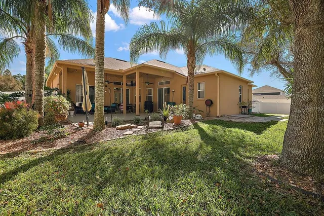a front view of a house with garden and patio