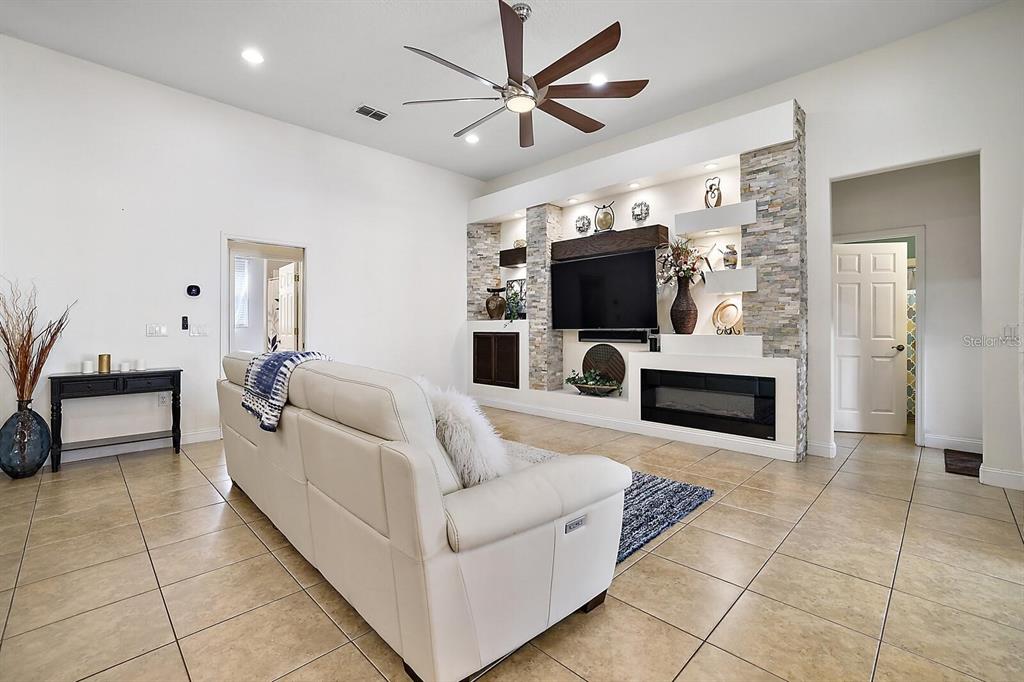 2847 Majestic Isle Drive Clermont, FL 34711 - Photo 5 of 25 a living room with furniture and a flat screen tv