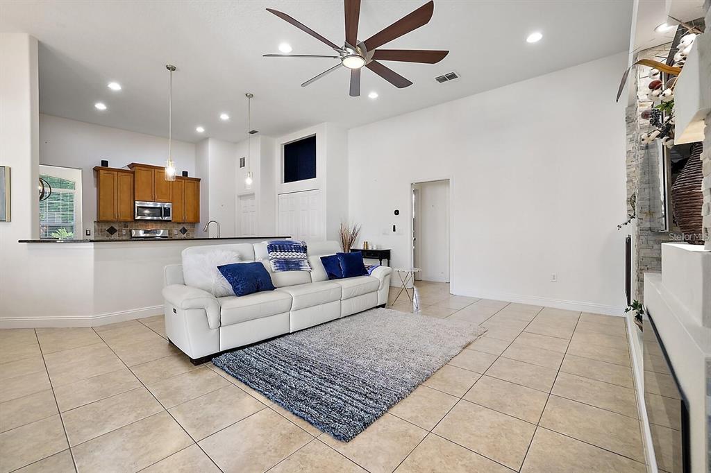 2847 Majestic Isle Drive Clermont, FL 34711 - Photo 6 of 25 a living room with furniture and a flat screen tv