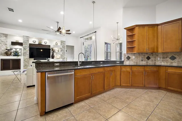 a kitchen with stainless steel appliances granite countertop a sink and a stove