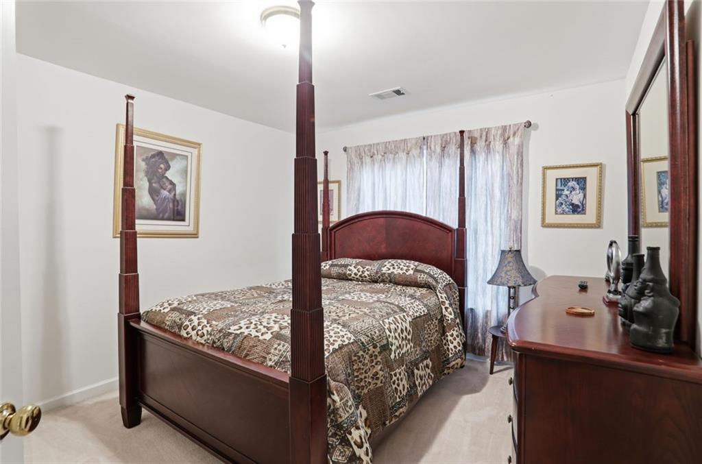 632 Grande View Stone Mountain, GA 30087 - Photo 18 of 46 a bedroom with bed and a window
