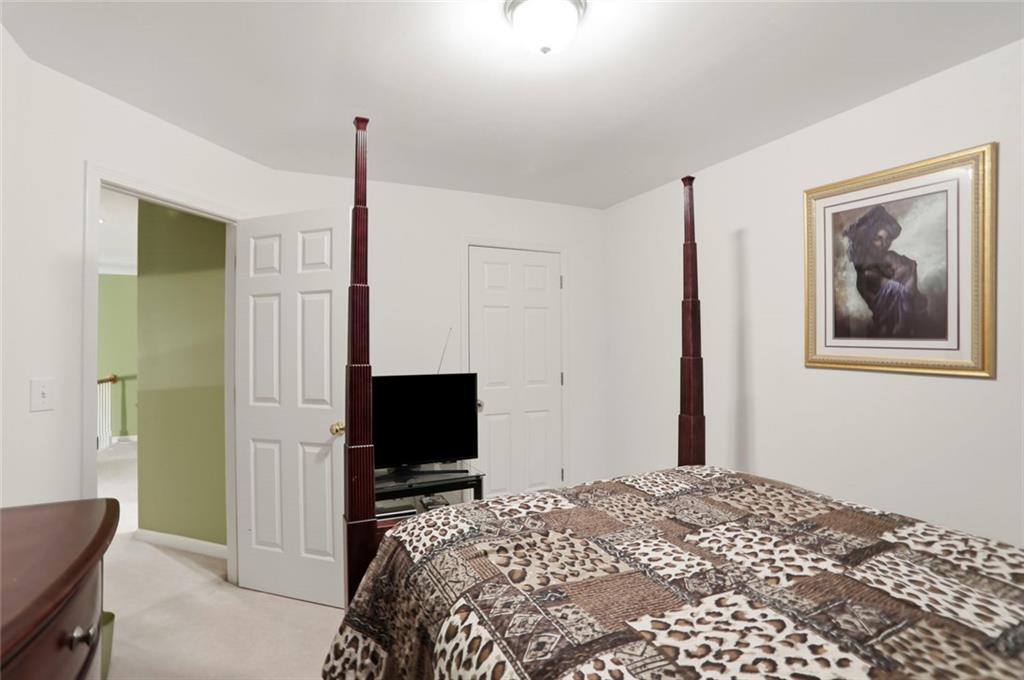 632 Grande View Stone Mountain, GA 30087 - Photo 19 of 46 a bedroom with a bed and a flat screen tv