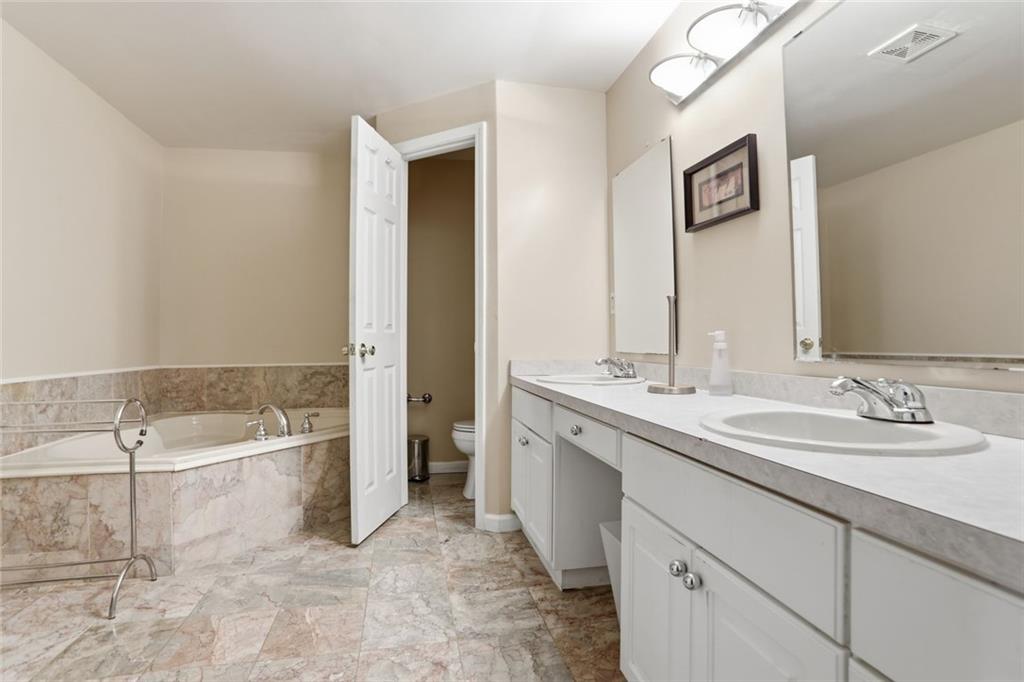 632 Grande View Stone Mountain, GA 30087 - Photo 41 of 46 a spacious bathroom with a bathtub and a sink