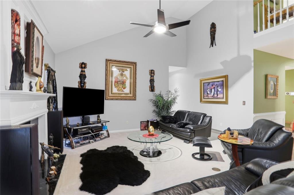 632 Grande View Stone Mountain, GA 30087 - Photo 9 of 46 a living room with furniture a flat screen tv and a window