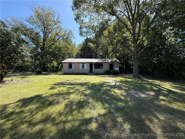 a house view with a sitting space and garden