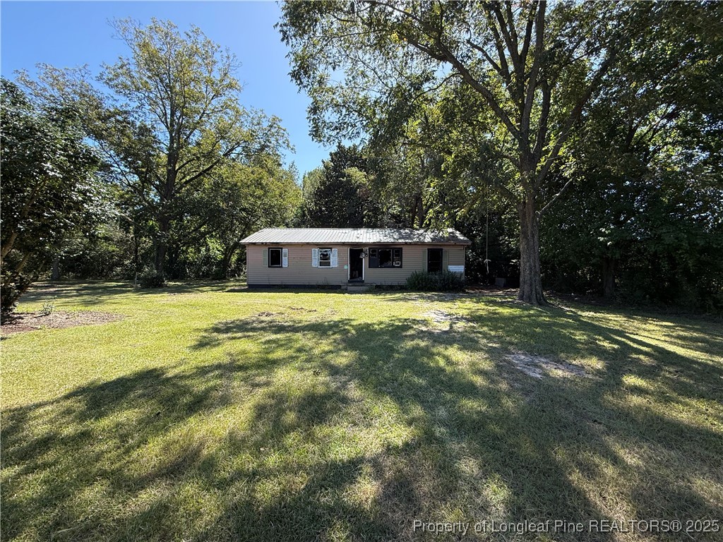 a house view with a sitting space and garden