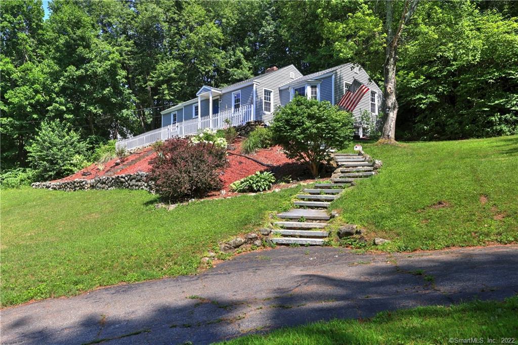 a front view of house with yard and green space