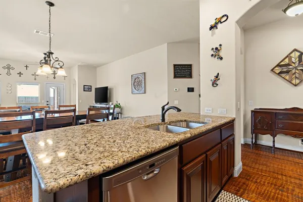 a kitchen with granite countertop kitchen island stainless steel appliances and a center island