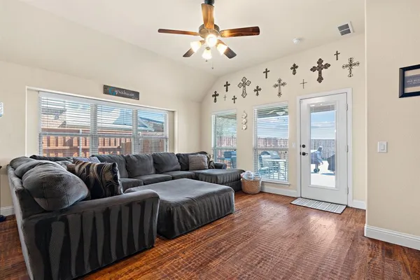 a living room with furniture and wooden floor
