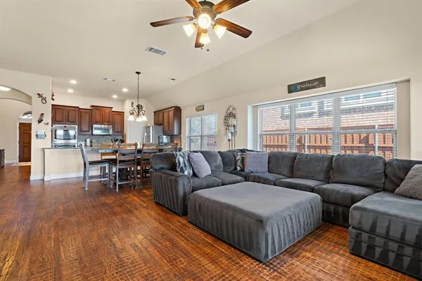 a living room with furniture and a wooden floor