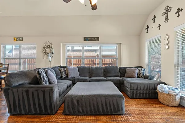 a living room with furniture a couch and a window