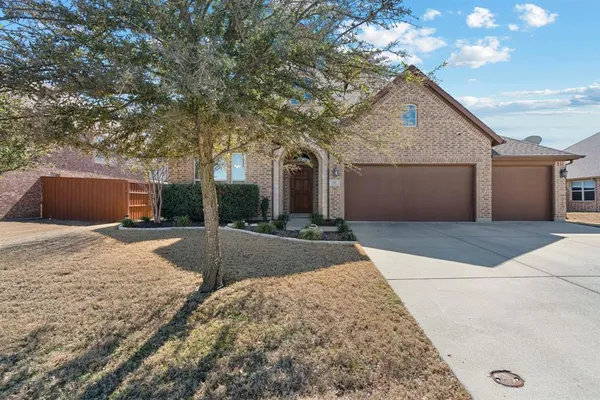 a front view of a house with yard and garage