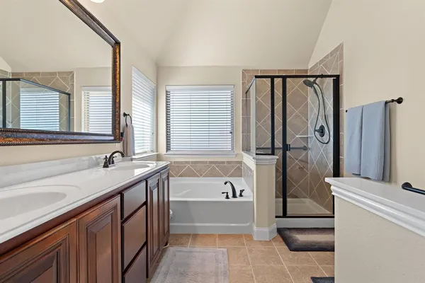 a bathroom with a tub sink and a mirror