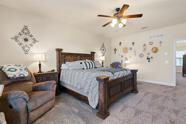 a bedroom with a bed couch and window