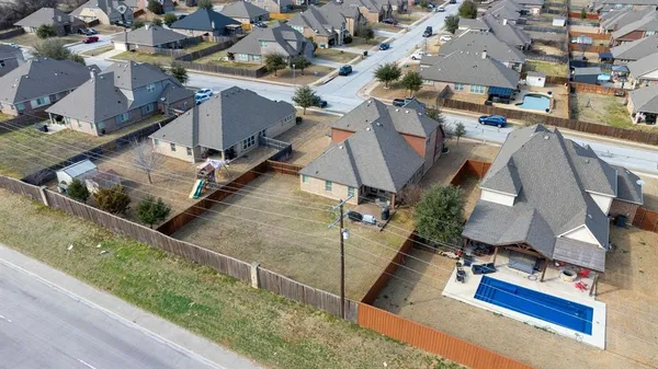 an aerial view of a house with a yard