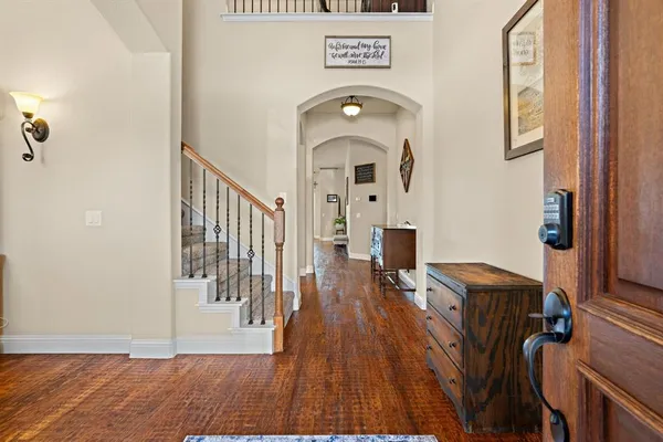 a view of a hallway with wooden floor and furniture