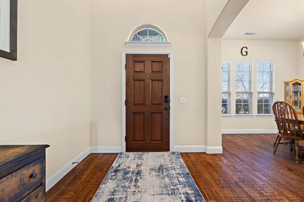 a view of an entryway with wooden floor