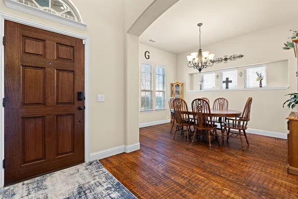 a view of a dining room with furniture and chandelier