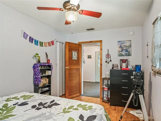 a bedroom with furniture and a flat screen tv
