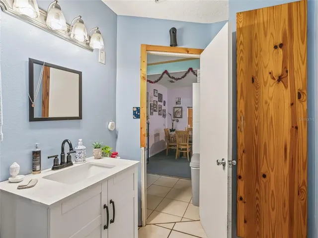 a view of a house with backyard and a tree