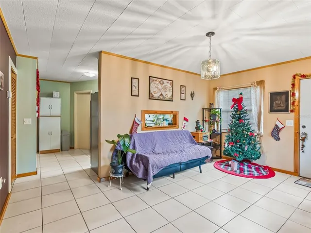 a living room with furniture and kitchen view