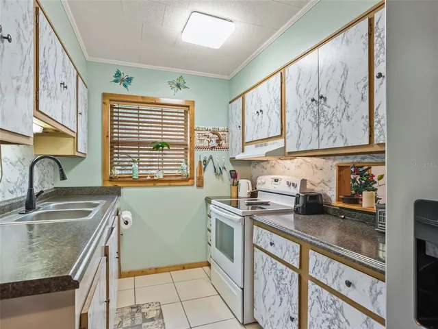 a kitchen with stainless steel appliances granite countertop a sink stove and cabinets