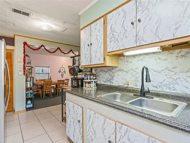a kitchen with stainless steel appliances granite countertop a sink and a counter top space