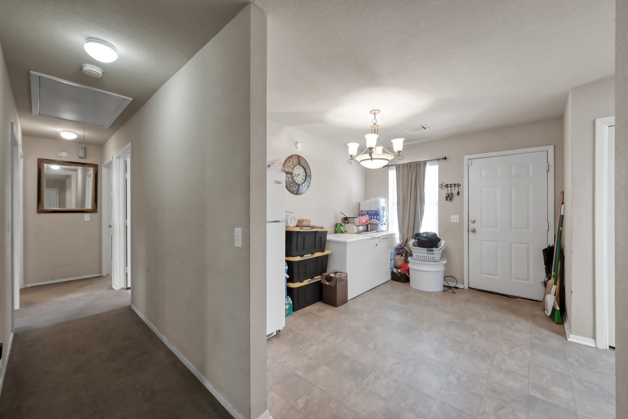 805 Webb Street Conroe, TX 77301 - Photo 7 of 19 a view of a hallway with dining room and chandelier