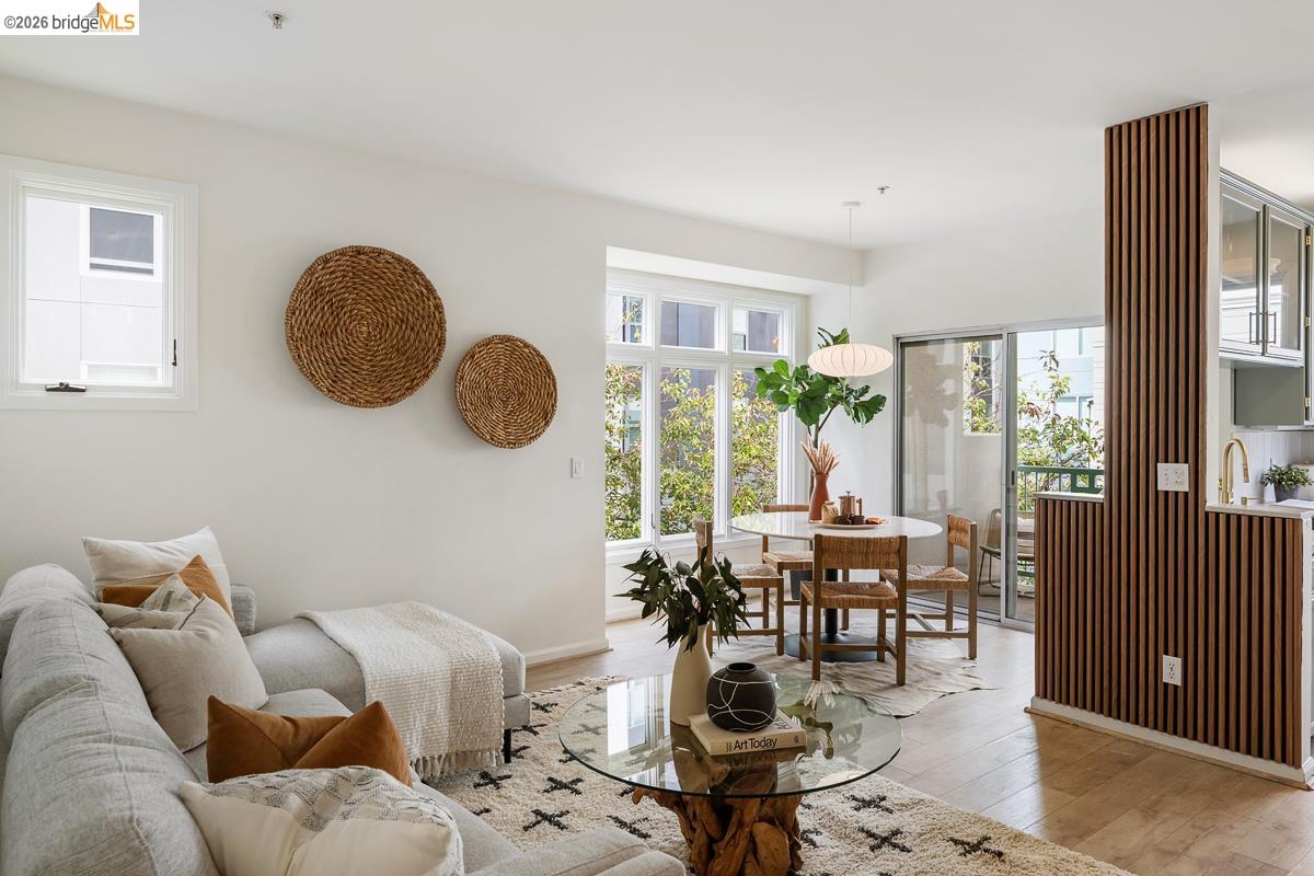 2029 Channing Way, Unit 3D Berkeley, CA 94704 - Photo 6 of 54 Open-concept living and dining area featuring light-toned wood-finish flooring, white walls, and a large window