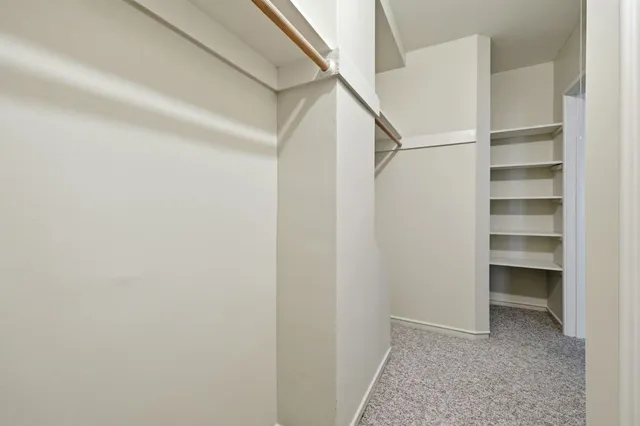 a bathroom with a tub a sink and mirror