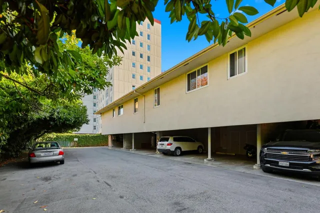 a view of swimming pool with a garden and trees