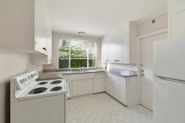 a kitchen with a stove a sink and a refrigerator