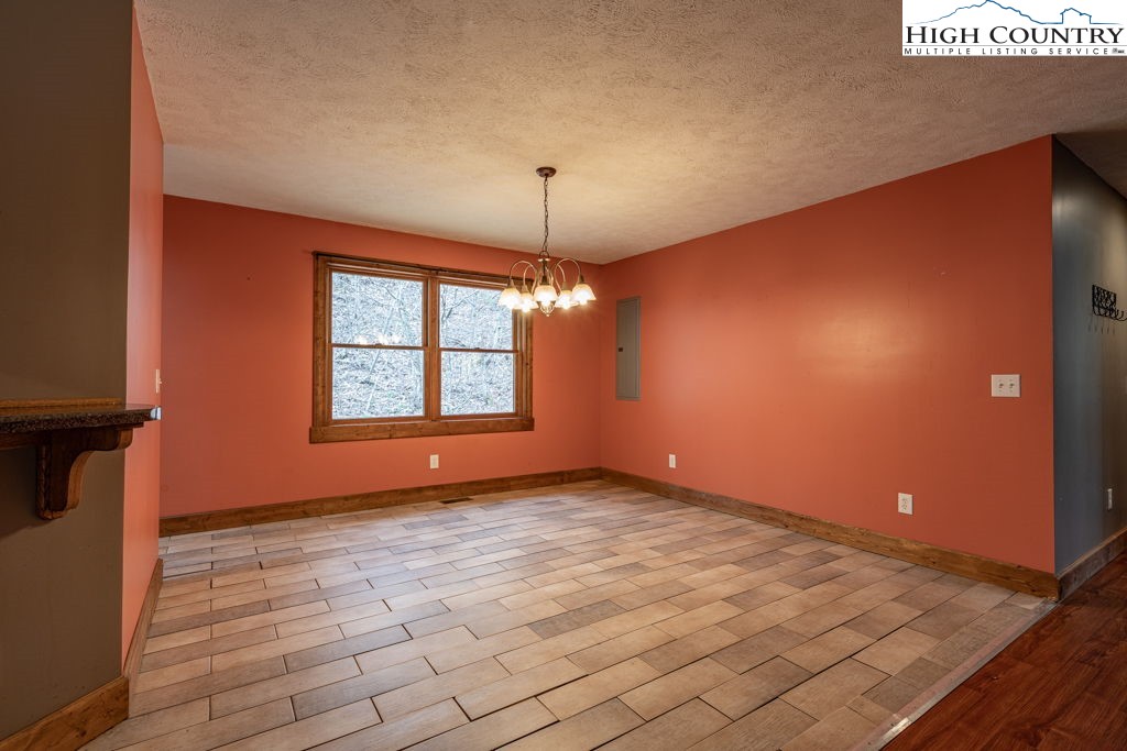 621 Trivette Hollow Road Creston, NC 28615 - Photo 11 of 43 a view of an empty room with window and chandelier fan