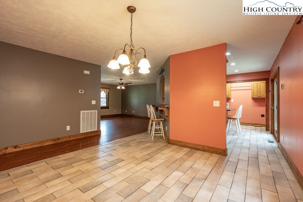 621 Trivette Hollow Road Creston, NC 28615 - Photo 12 of 43 a view of a room with a chandelier and wooden floor