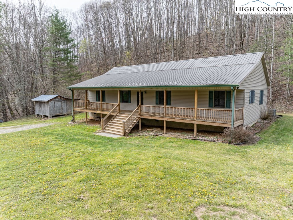 621 Trivette Hollow Road Creston, NC 28615 - Photo 2 of 43 a view of a house with a backyard and a patio