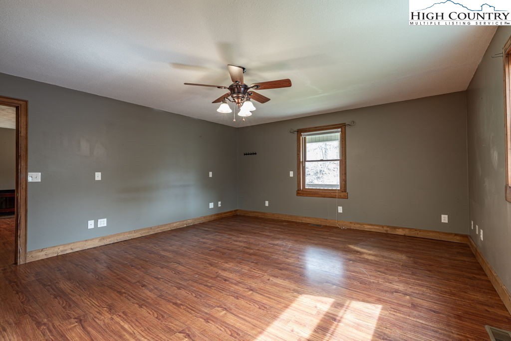 621 Trivette Hollow Road Creston, NC 28615 - Photo 22 of 43 a view of an empty room with window and wooden floor