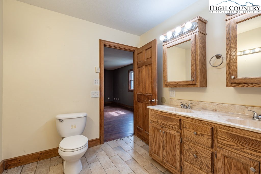 621 Trivette Hollow Road Creston, NC 28615 - Photo 25 of 43 a bathroom with a toilet sink and mirror