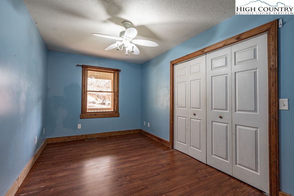 621 Trivette Hollow Road Creston, NC 28615 - Photo 26 of 43 a view of an empty room with wooden floor and a window