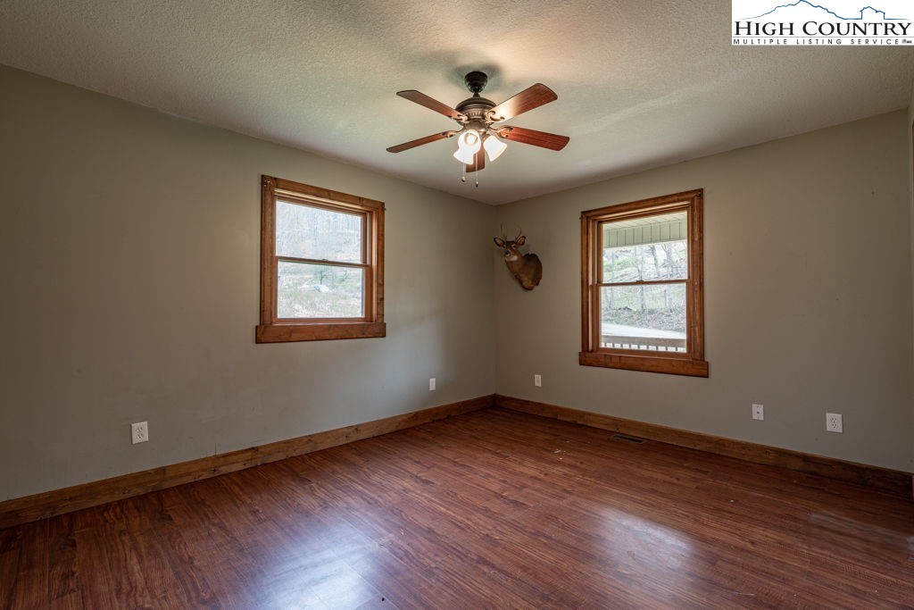 621 Trivette Hollow Road Creston, NC 28615 - Photo 31 of 43 a view of an empty room with wooden floor and a window