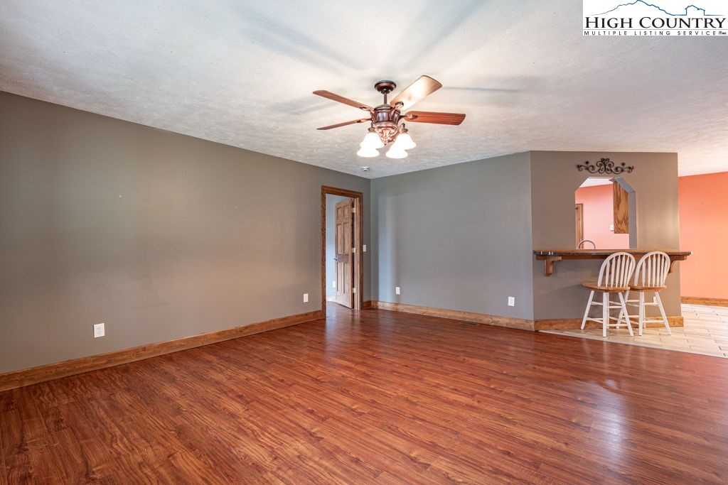 621 Trivette Hollow Road Creston, NC 28615 - Photo 7 of 43 a view of an empty room with a window and wooden floor