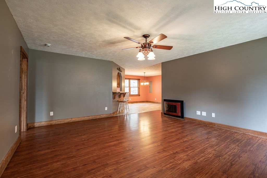 621 Trivette Hollow Road Creston, NC 28615 - Photo 8 of 43 a view of an empty room with window and wooden floor