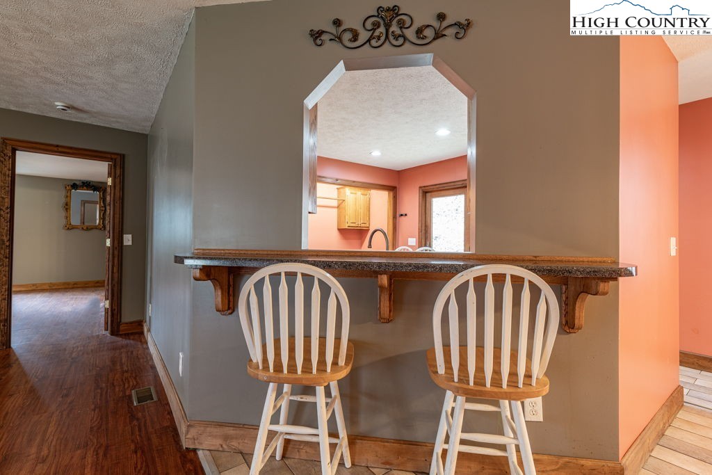 621 Trivette Hollow Road Creston, NC 28615 - Photo 10 of 43 a view of a dining room with furniture and wooden floor