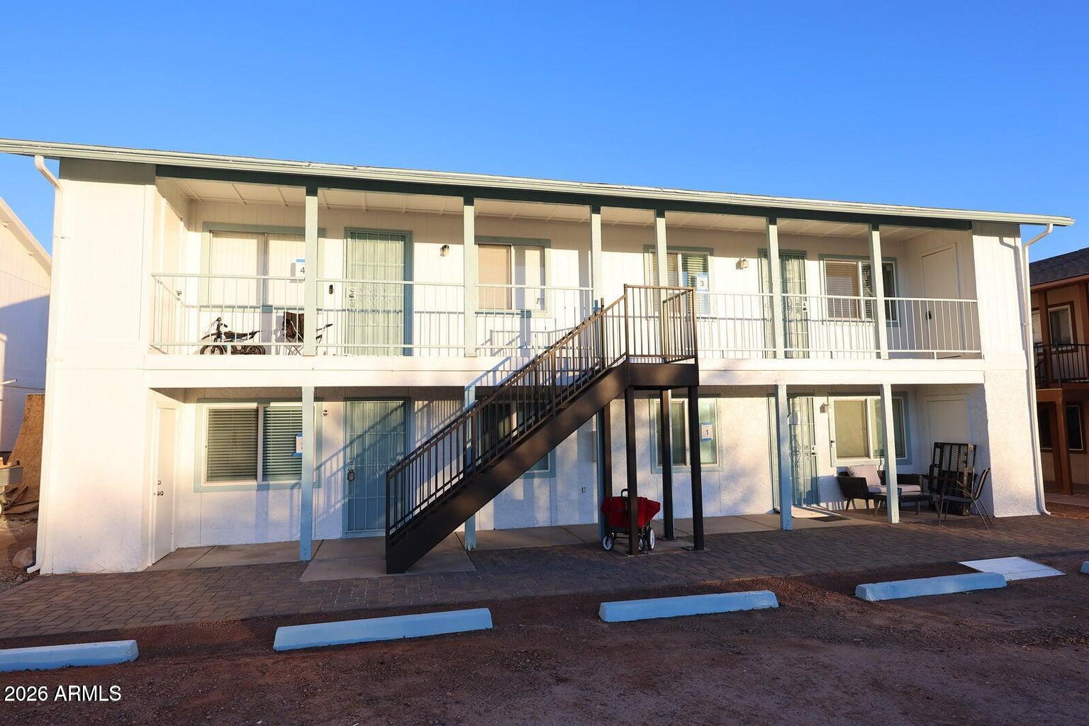 a living room with a large window and furniture