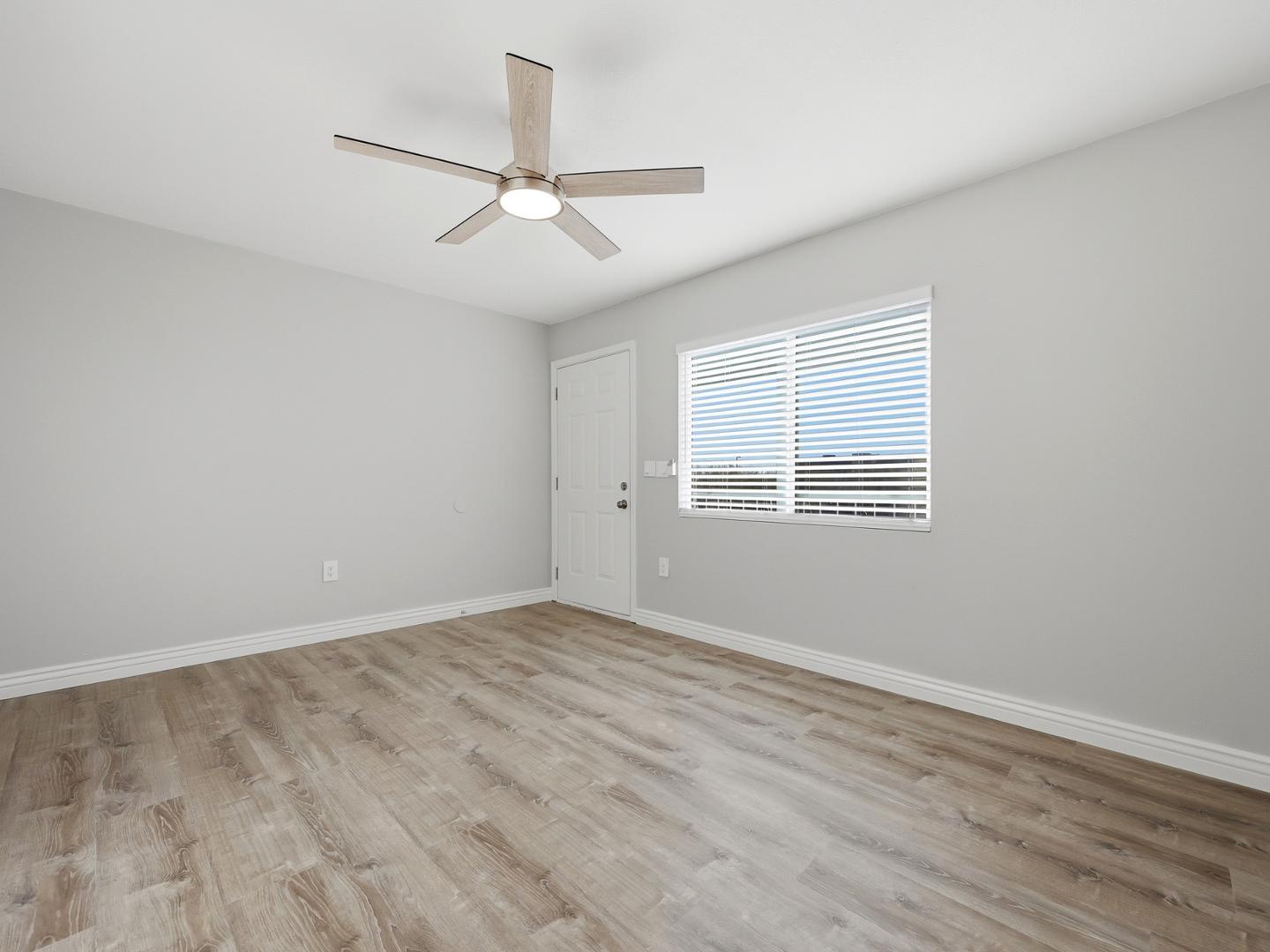 127 South Outpost Road, Unit 4 Apache Junction, AZ 85119 - Photo 5 of 13 wooden floor in an empty room with a window