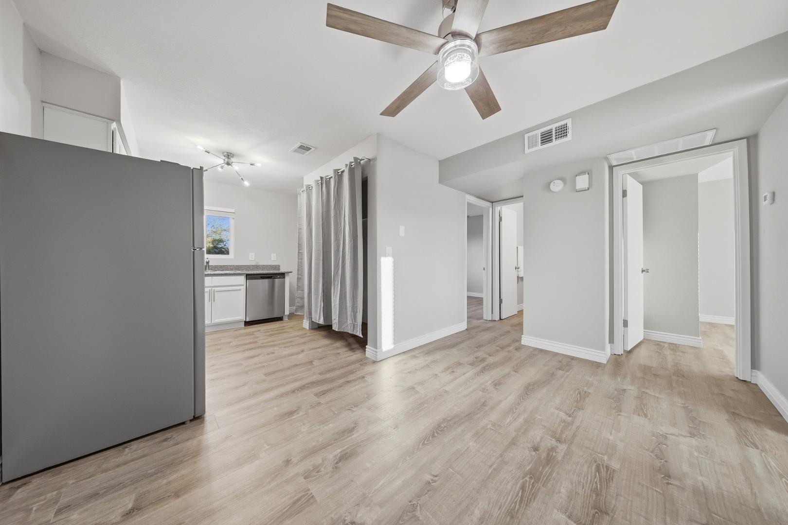 127 South Outpost Road, Unit 4 Apache Junction, AZ 85119 - Photo 6 of 13 a view of an empty room with wooden floor and a ceiling fan