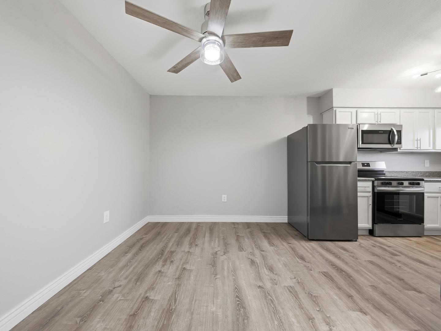 127 South Outpost Road, Unit 4 Apache Junction, AZ 85119 - Photo 7 of 13 a view of a kitchen with a stove cabinets and a ceiling fan