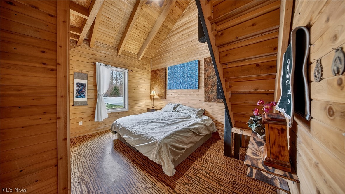 1693 Middleton Road Hudson, OH 44236 - Photo 11 of 48 Bedroom with wood walls, lofted ceiling with beams, wood ceiling, and wood finished floors