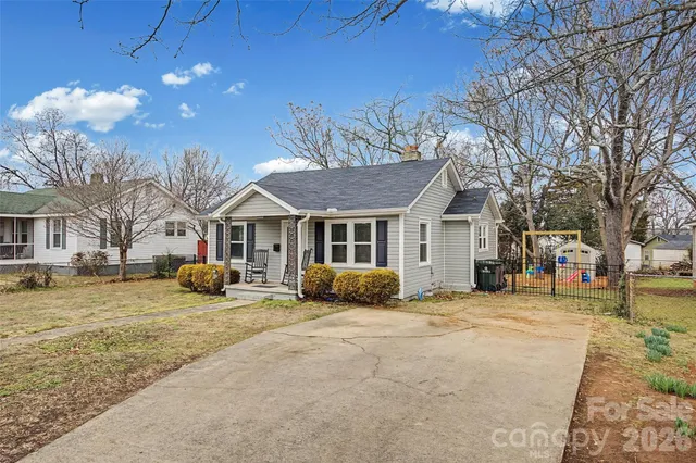 a view of a house with a yard covered in snow